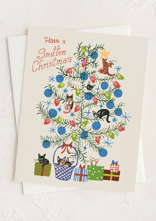A card with illustration of cats in a tree, text reads "Have a smitten christmas".