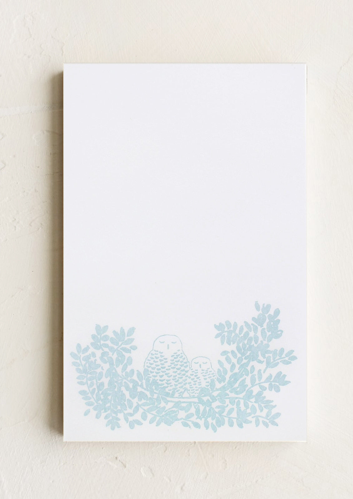 A letterpress printed notepad with owl design at bottom.