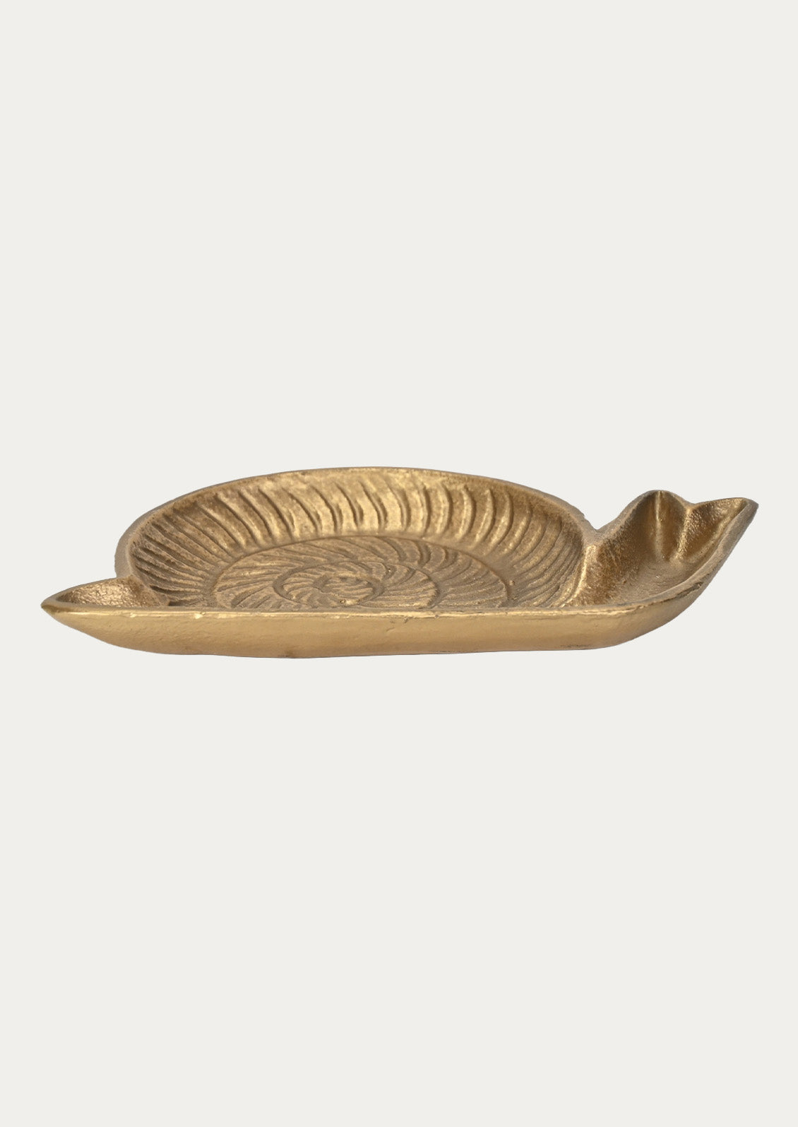 Side view of a handcrafted cast iron catchall tray in the shape of s snail in a gold finish on a white background.