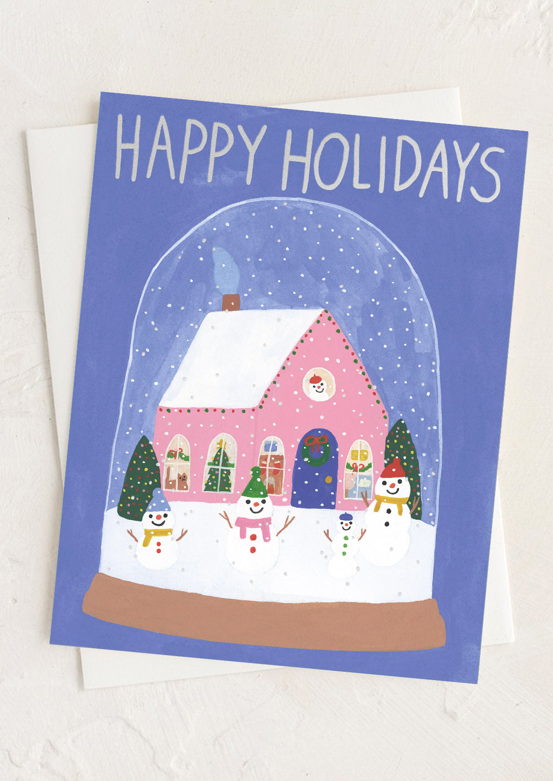 A greeting card with illustration of snowmen inside a snow globe, text reads "Happy Holidays".