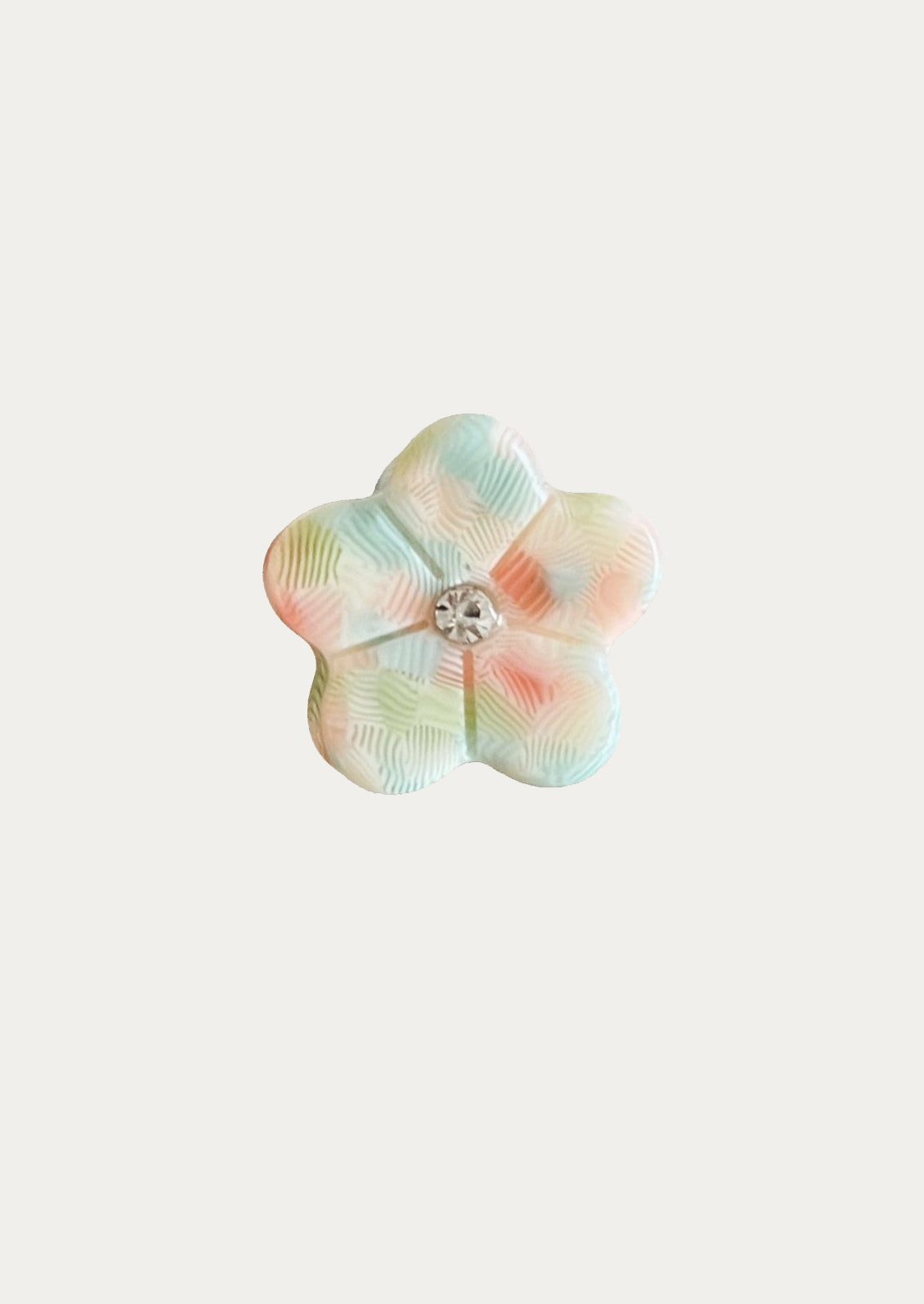 Multicolored flower-shaped mini hair claw on a white background