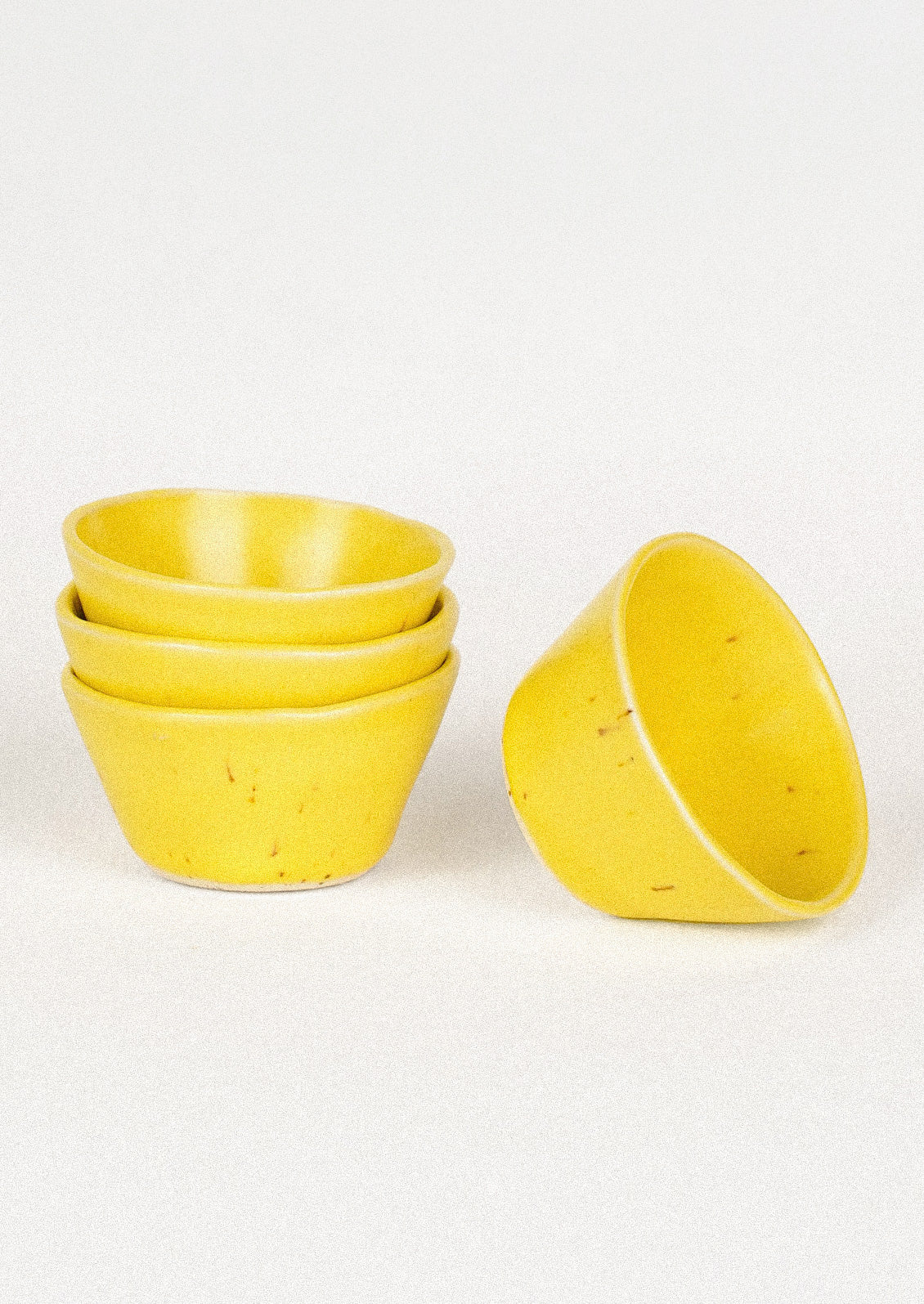 Small ceramic bowls in yellow.