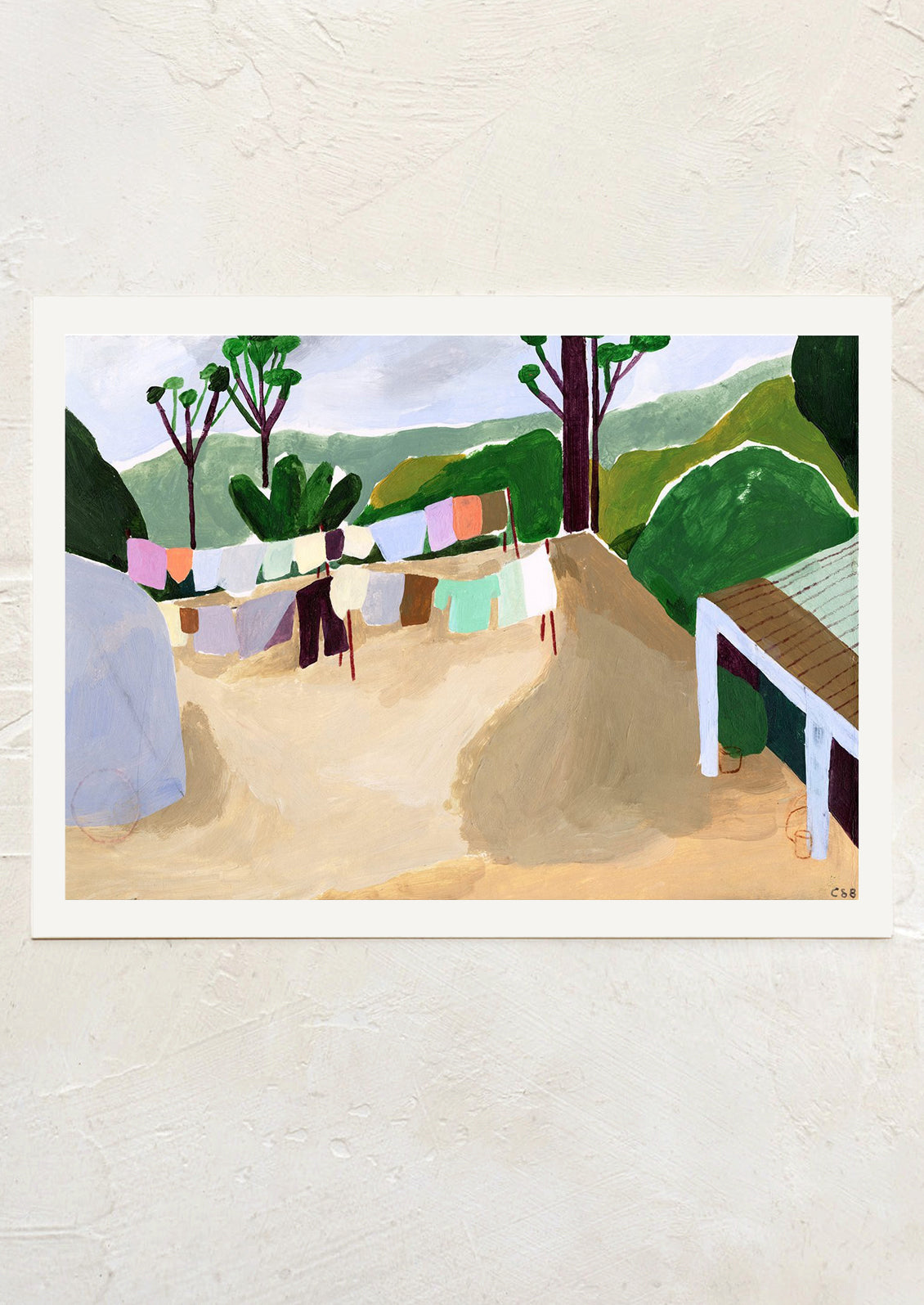 An art print of a painting of colorful clothes hanging on a clothesline, in mountainous setting.