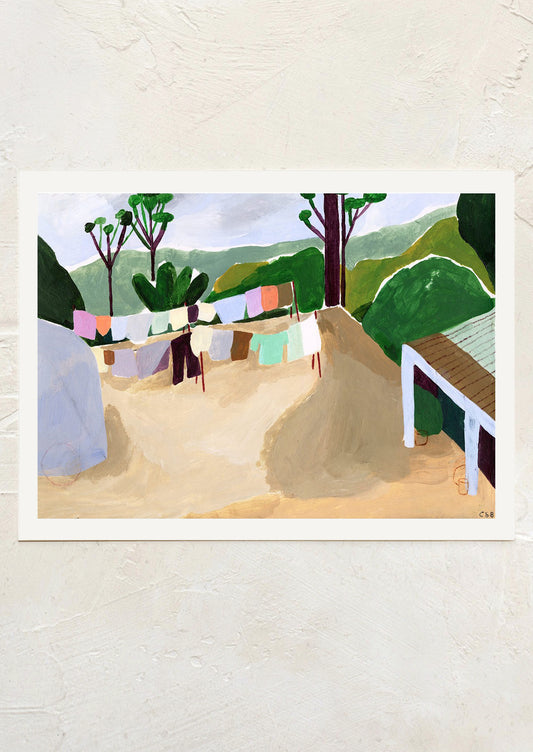 An art print of a painting of colorful clothes hanging on a clothesline, in mountainous setting.