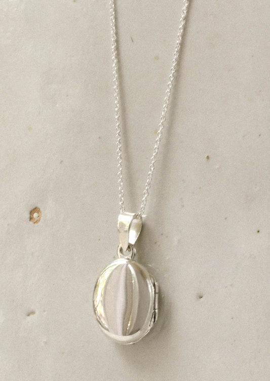 A minimal sterling silver locket.