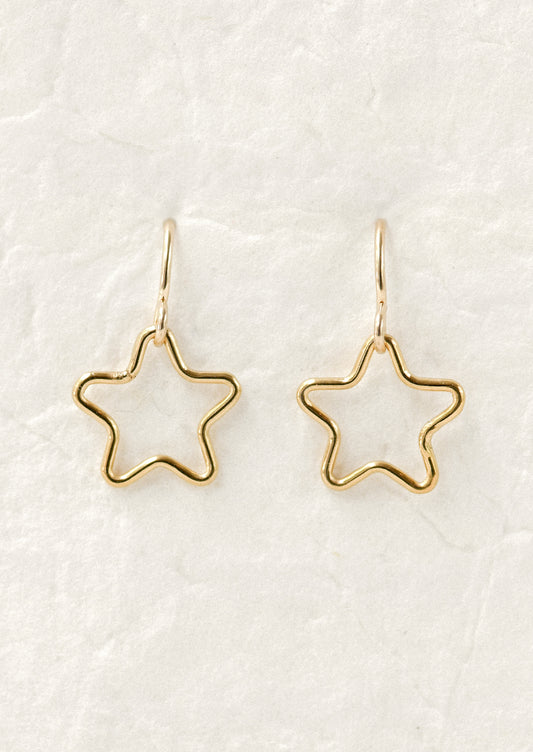 A pair of gold earrings with dangling cut out stars.