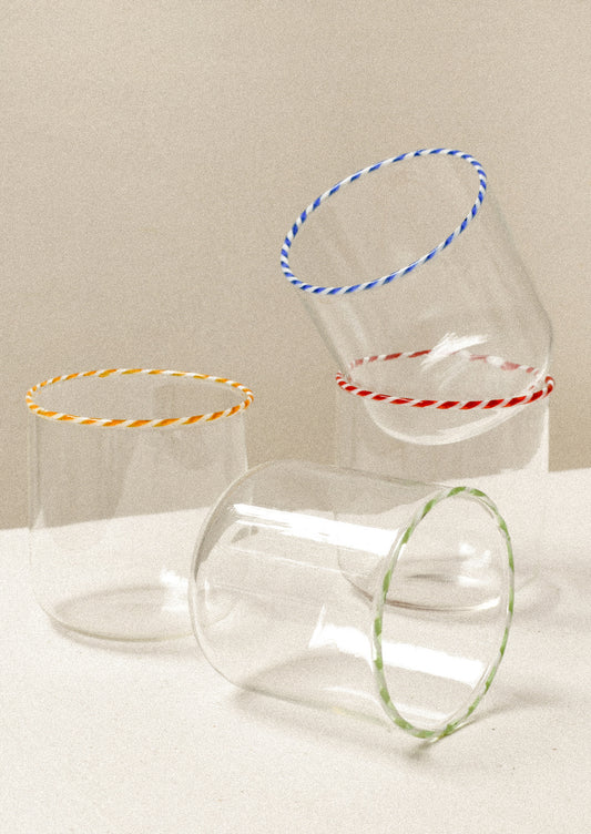 Clear glass drinking glasses with colorful striped rims