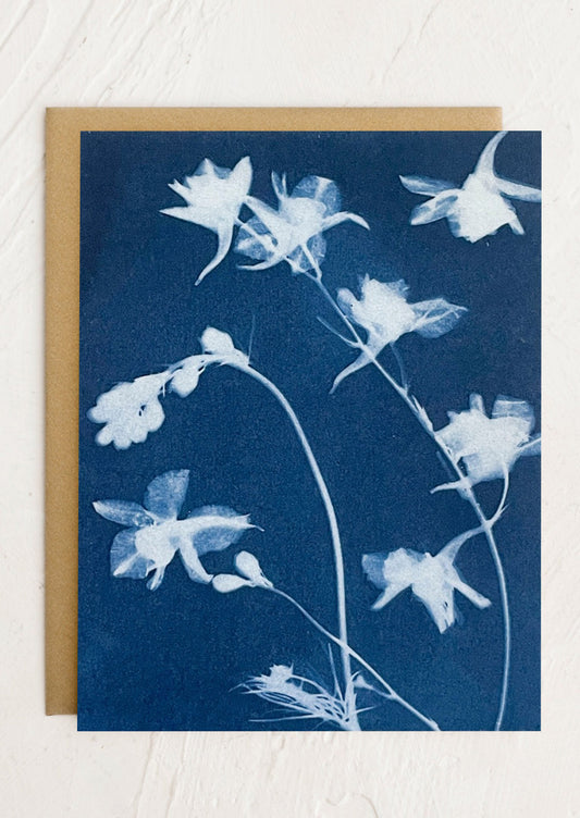 A cyanotype print greeting card with white columbine floral pattern.