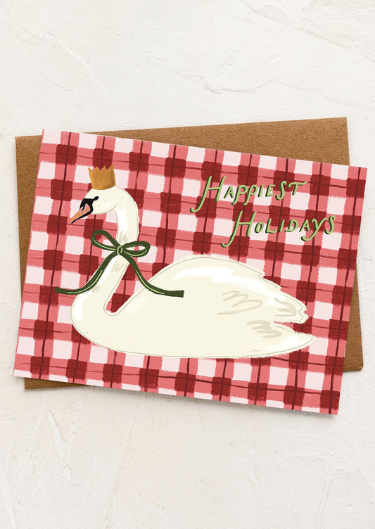 Holiday card with swan illustration and 'Happiest Holidays' text on a red and white checkered background.