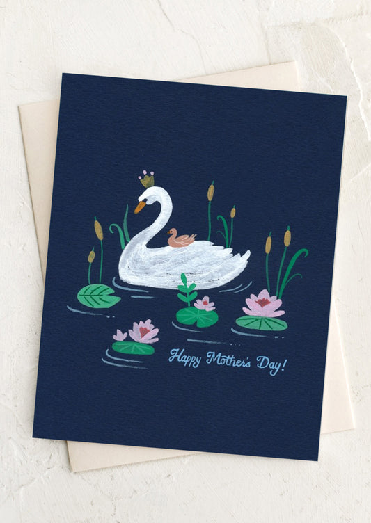 Greeting card with a swan and cygnets on water lilies and the text 'Happy Mother's Day!' on a white background.