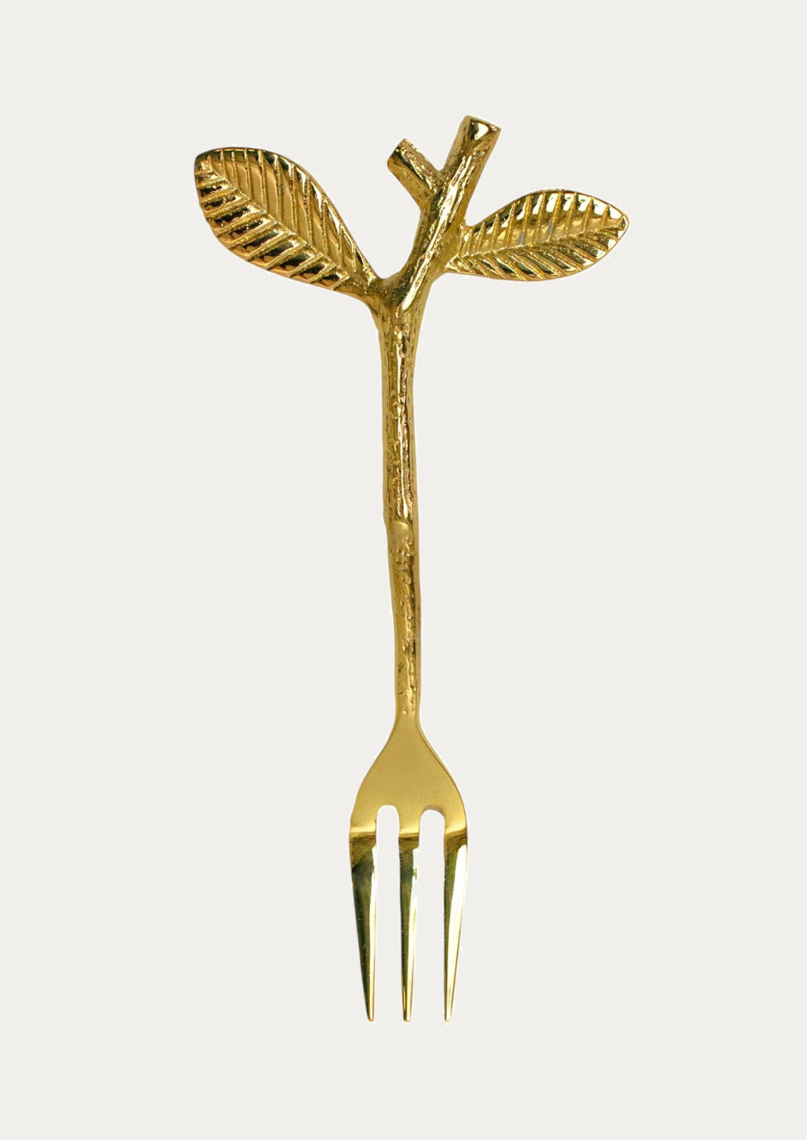 Gold fork with leaf design on a white background