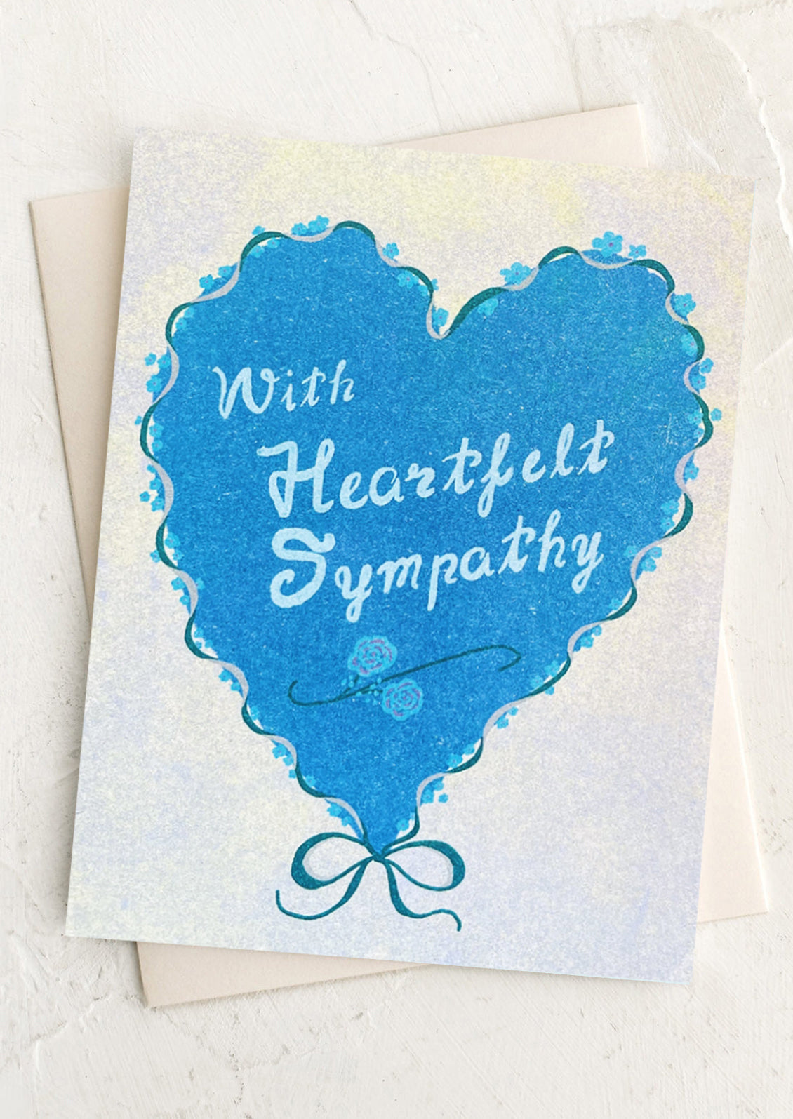 Card with blue heart shape and 'With Heartfelt Sympathy' text on a white background
