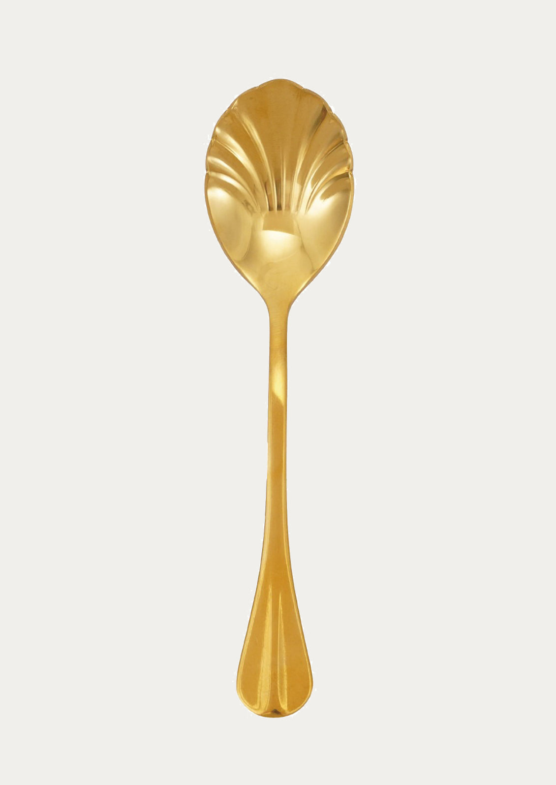 Gold spoon with shell design on a light gray background