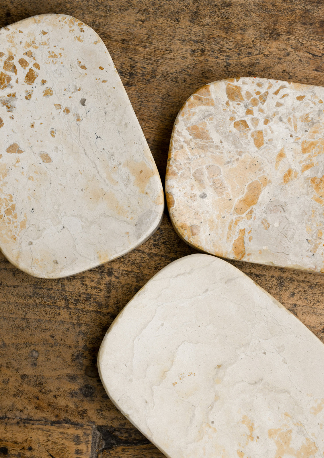 Variations of tan marble soap dishes, all are unique.