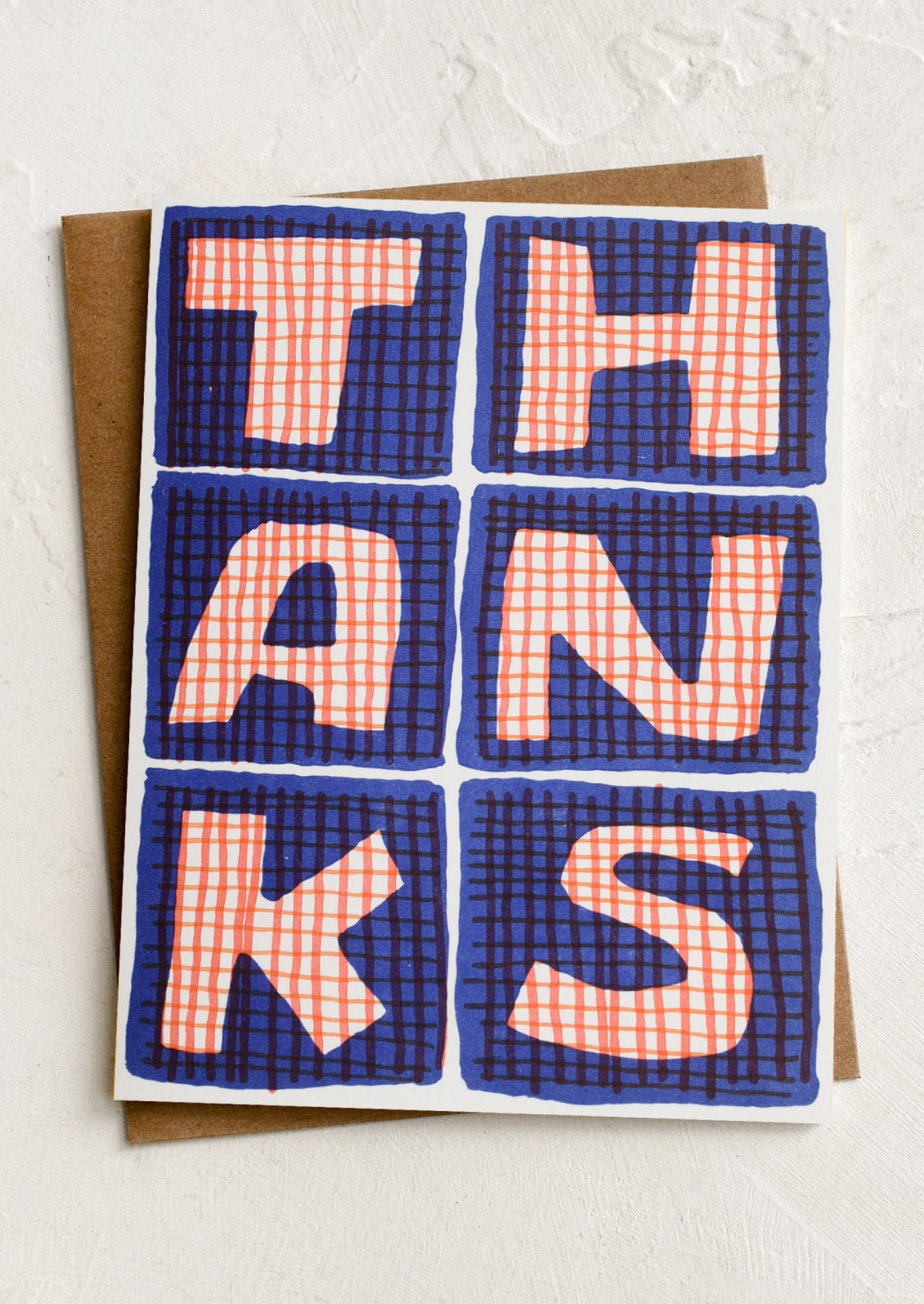 Greeting card with 'THANKS' in checkered squares on a white background