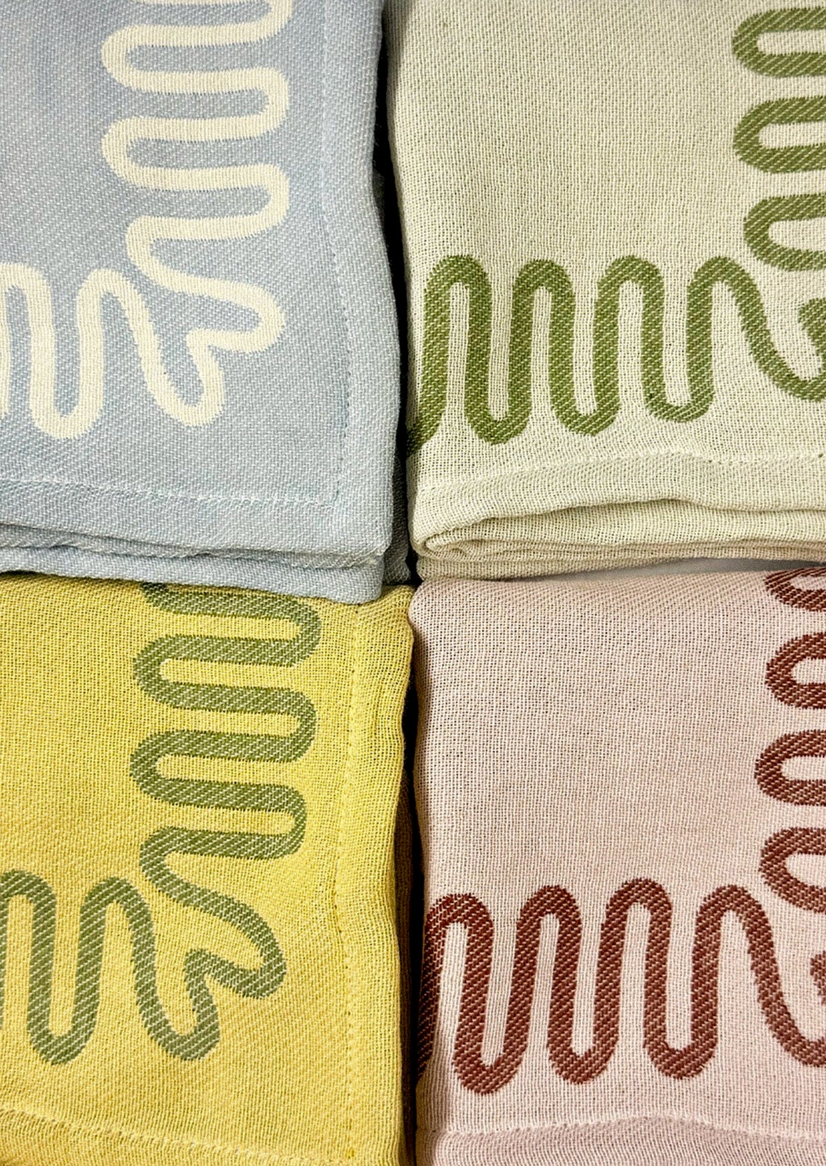 Dish towels with squiggle borders.