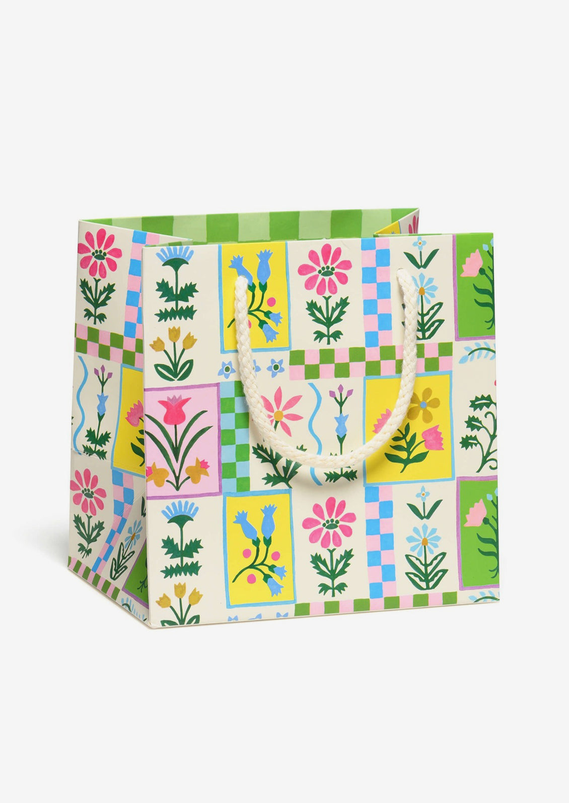 A small square shaped gift bag in white with multicolor floral tile print.
