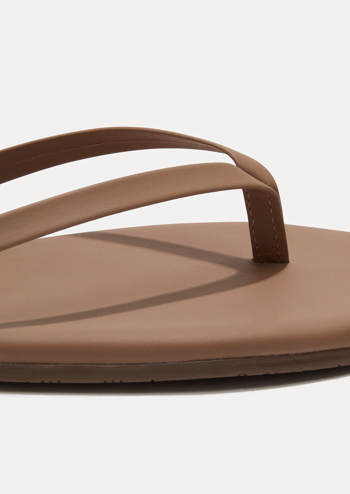 A leather skinny strap TKEES sandal in nude.