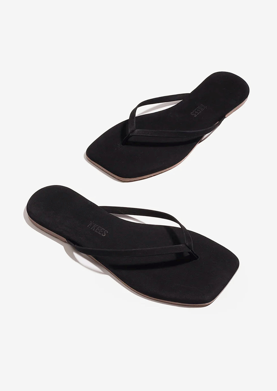 A pair of suede square toe TKEES sandals in black.