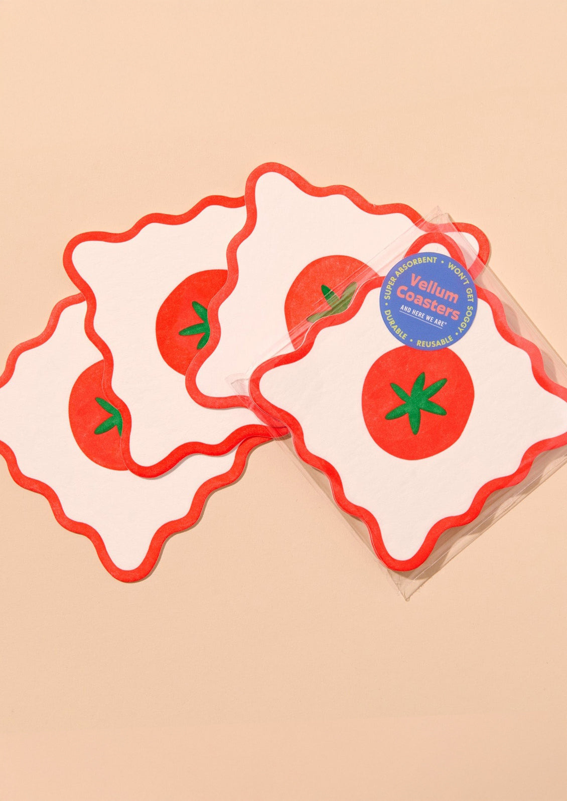Decorative paper coasters with wavy edges and tomato motif.