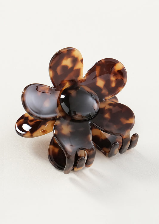 Tortoiseshell flower-shaped hair clip on a white background