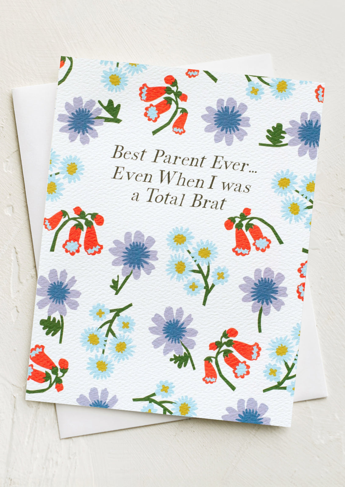 A floral print card reading "Best parent ever... even when I was a total brat!".