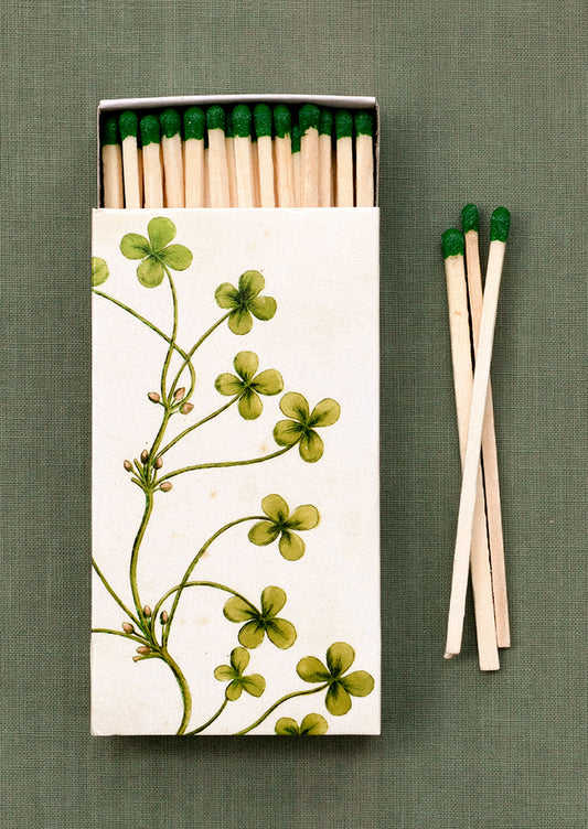 Matches with a floral design on the box against a green background