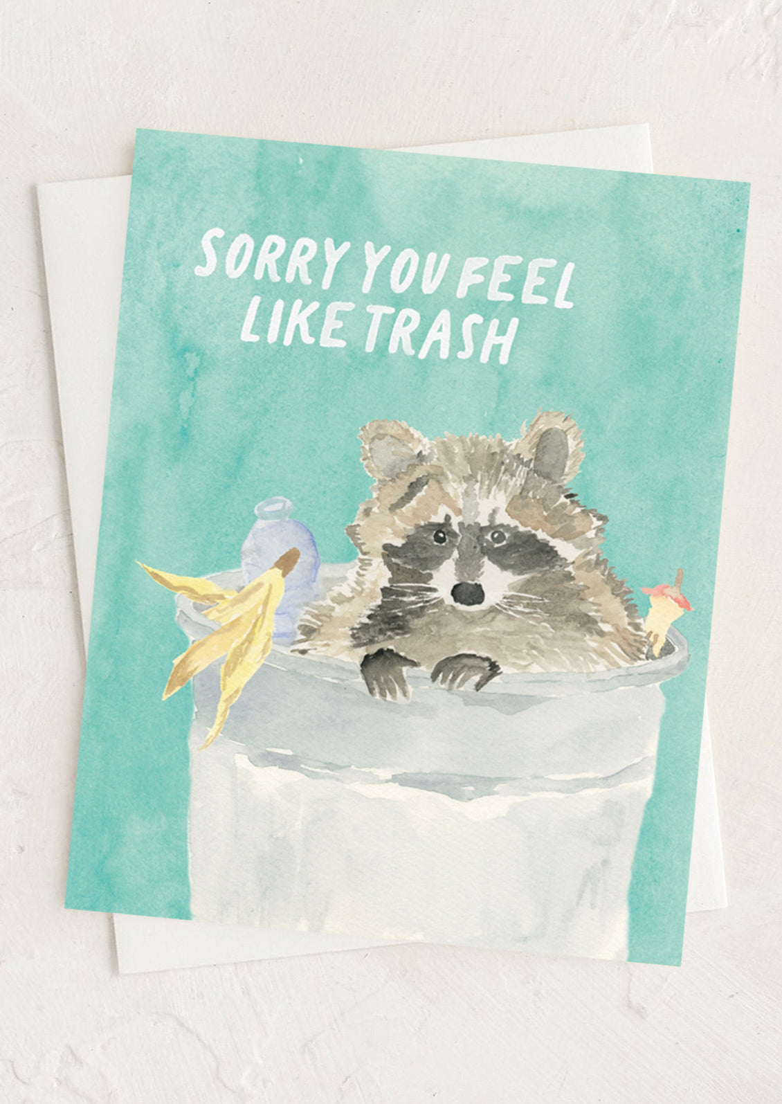Card with a raccoon illustration and text 'Sorry you feel like trash' on a light background