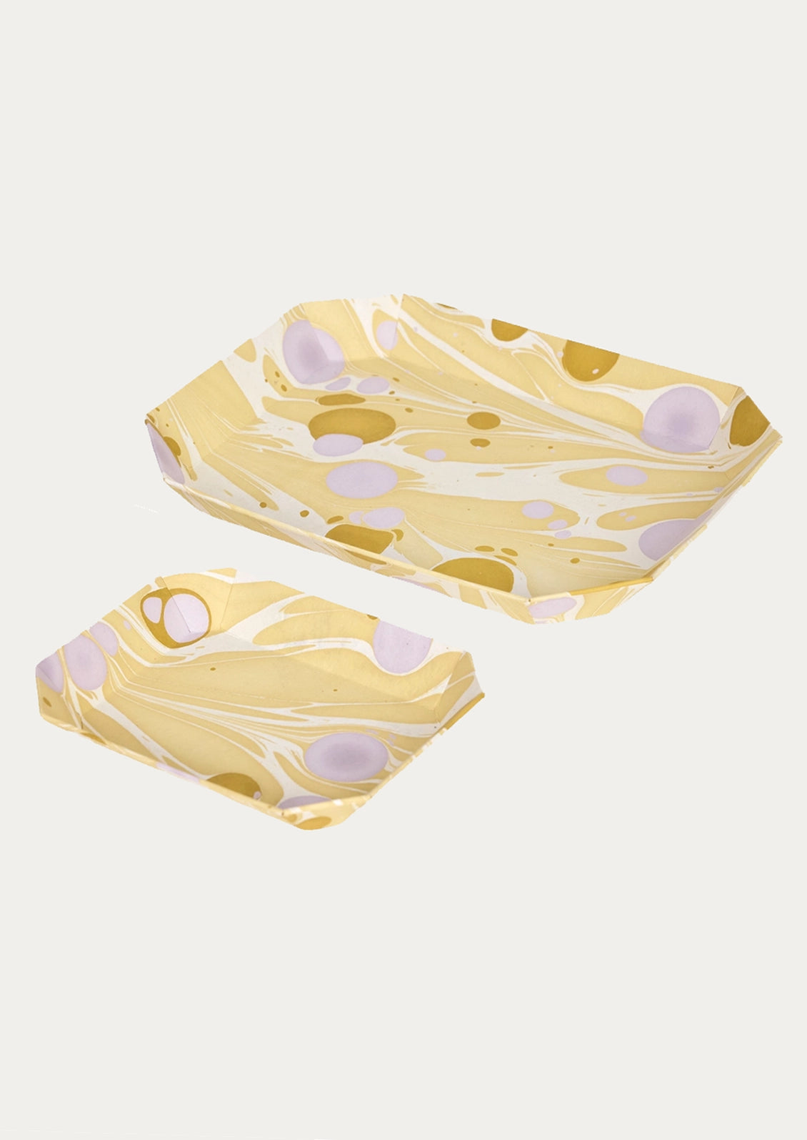 Two rectangular paper trays with a yellow, white, and gold marbled pattern and light purple circular accents, shown on a light gray background.