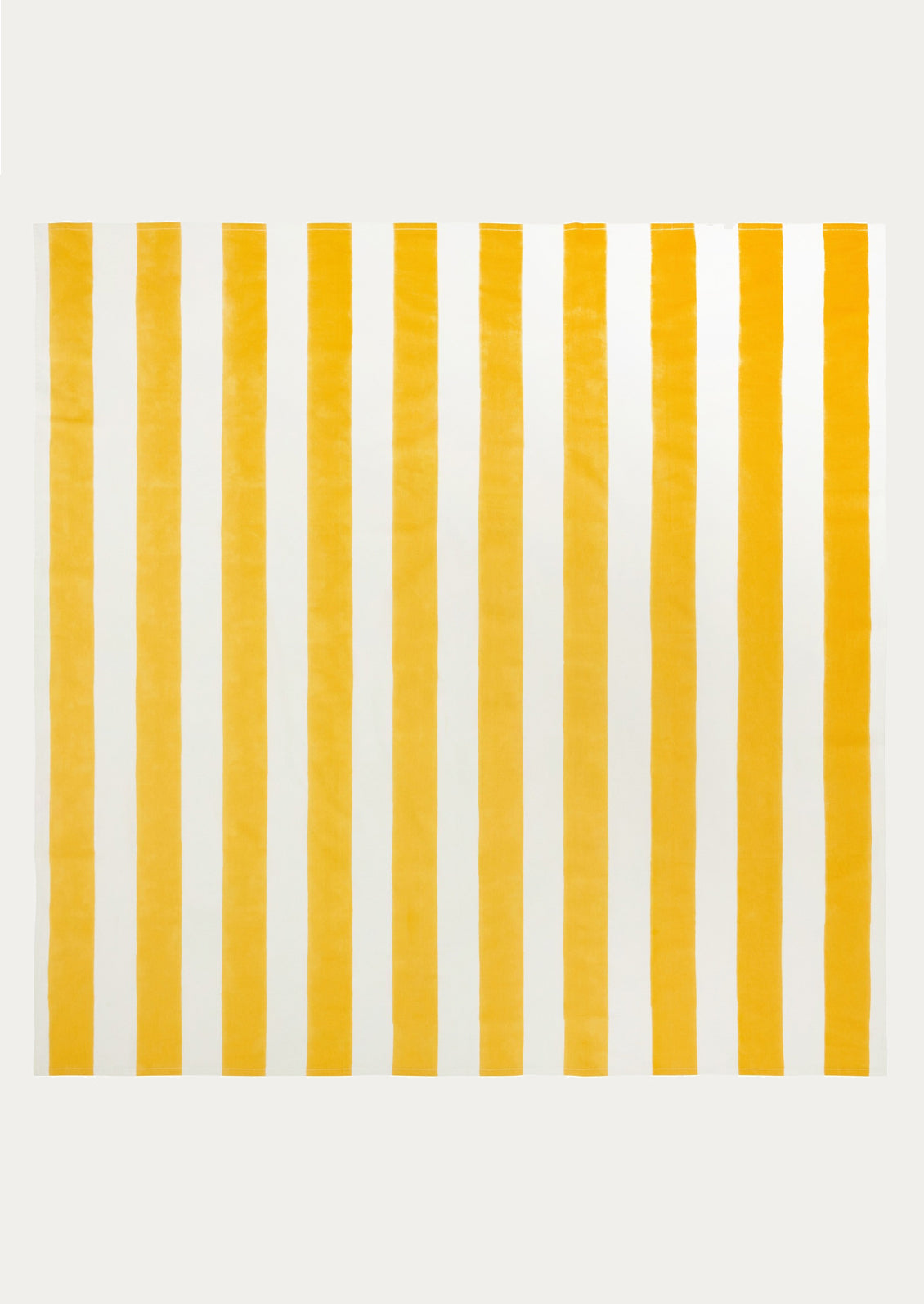 A tablecloth with wide yellow and white stripe pattern.