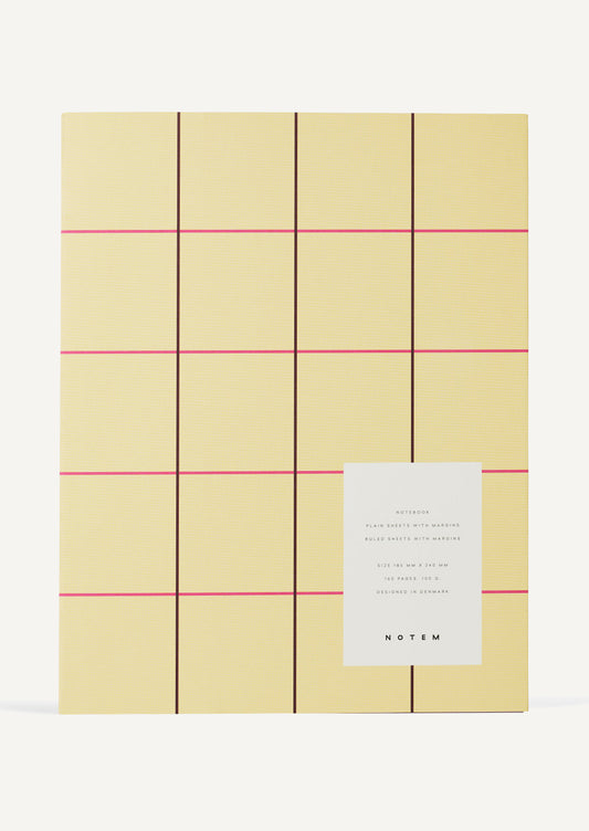 A notebook with pale yellow cover with pink grid check pattern.