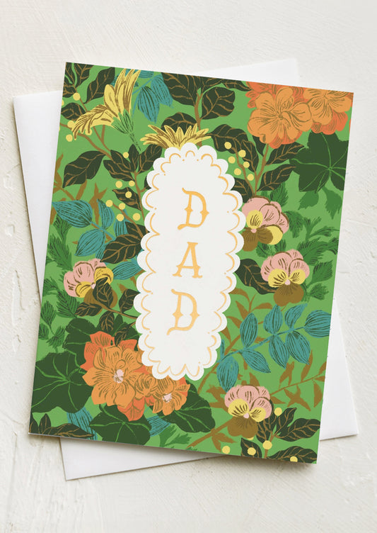 A floral print card with frame at center reading "DAD".