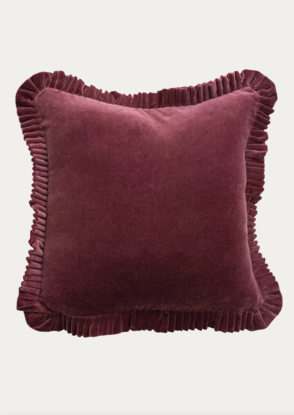 Velvet pillow with ruffled edge.