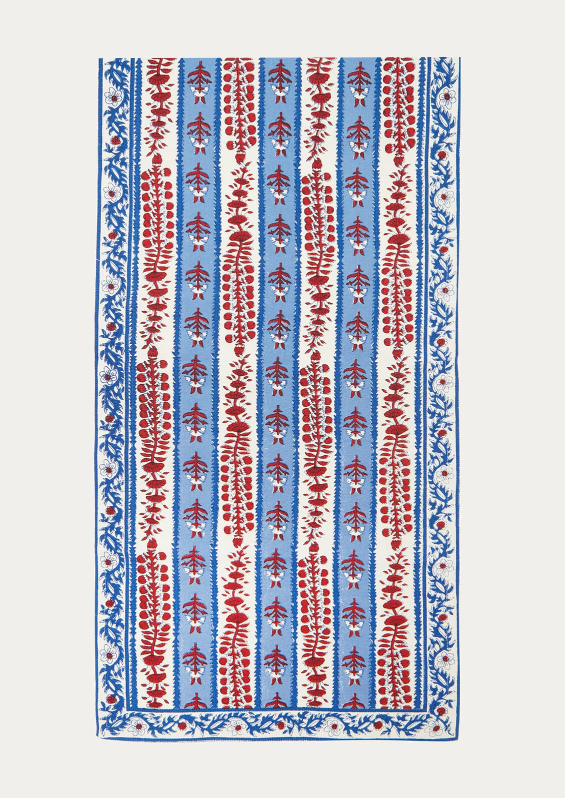 Decorative table runner with red and blue block printed floral pattern on a white background.