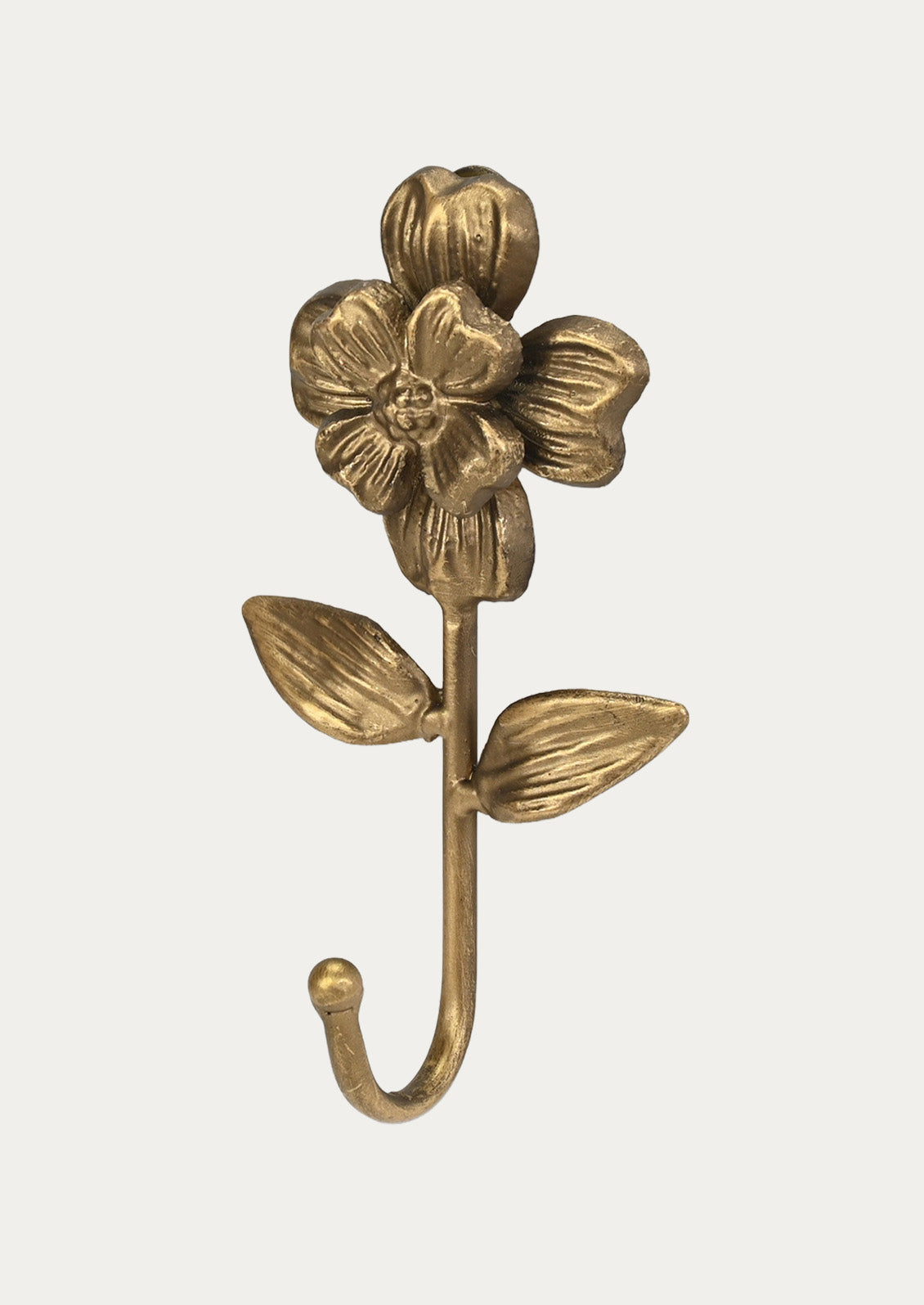 Side view of a handcrafted cast iron wall hook in the shape of a flower in a gold finish on a white background.