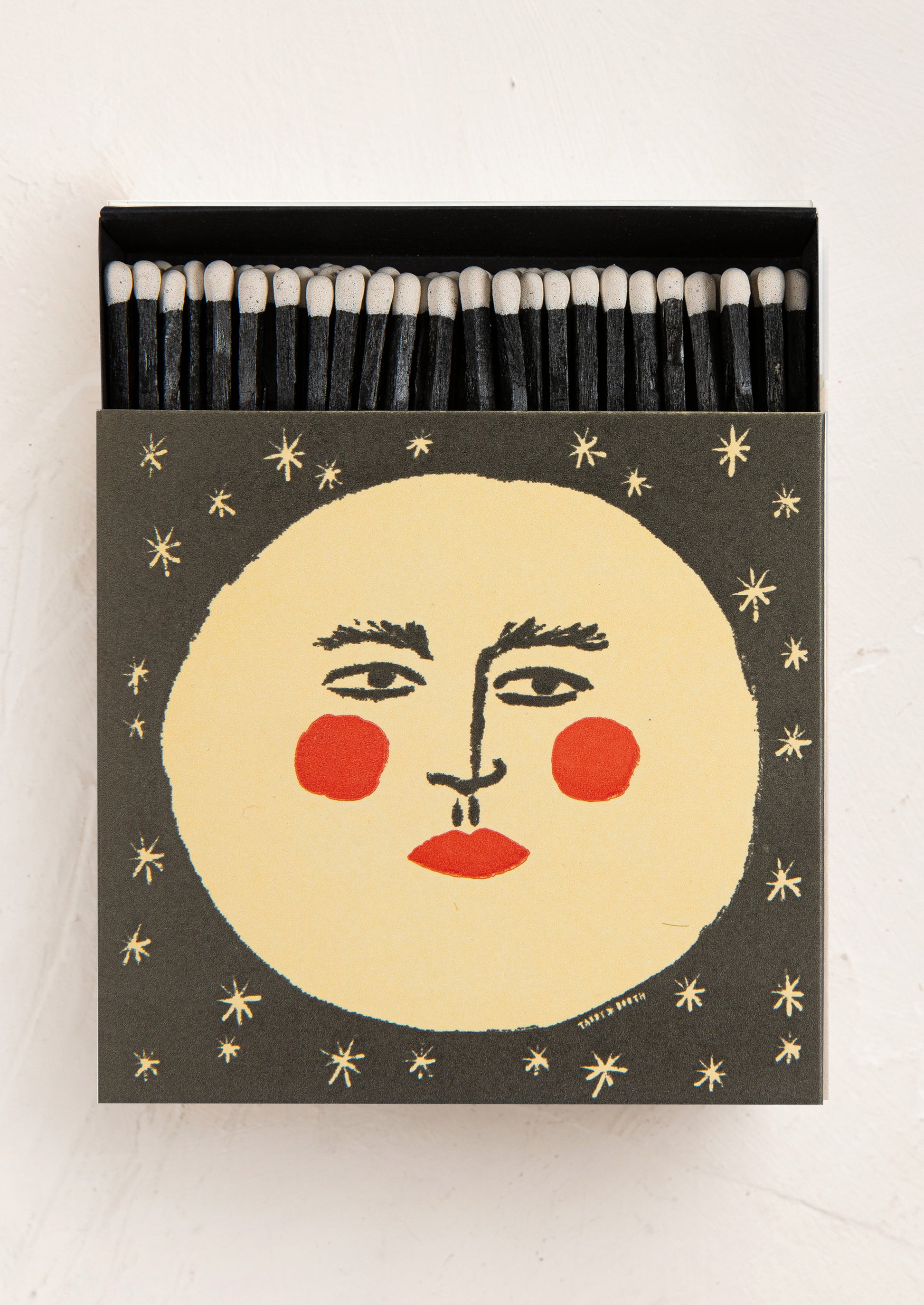 Matches with a face design on the box against a white background