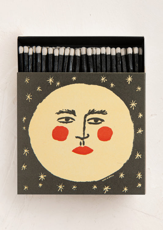 Matches with a face design on the box against a white background