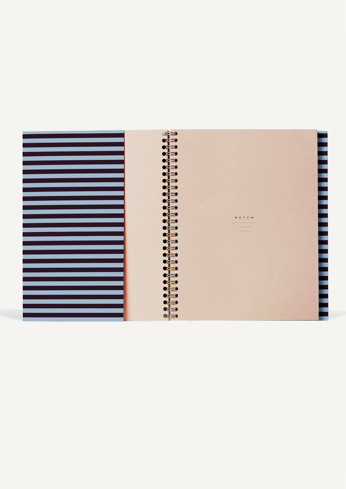 A spiral bound notebook with blank left side, ruled right side.