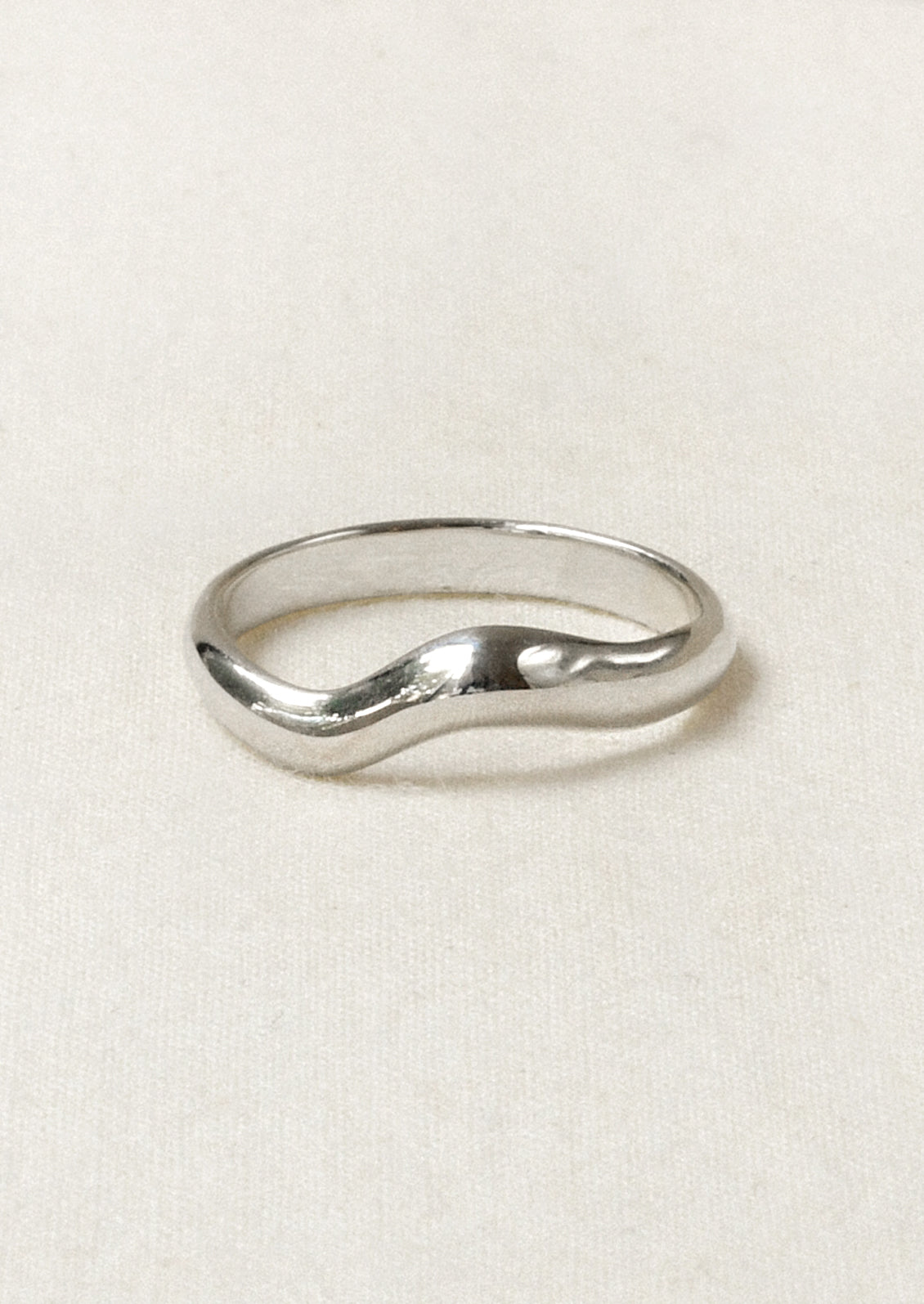 A sterling silver ring with a wavy design.