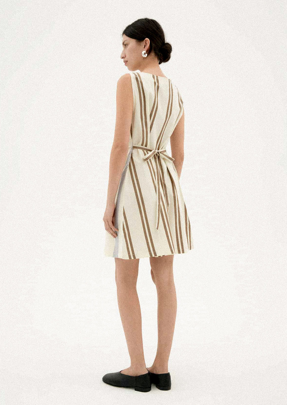 A woman wearing a two-tone striped short dress.