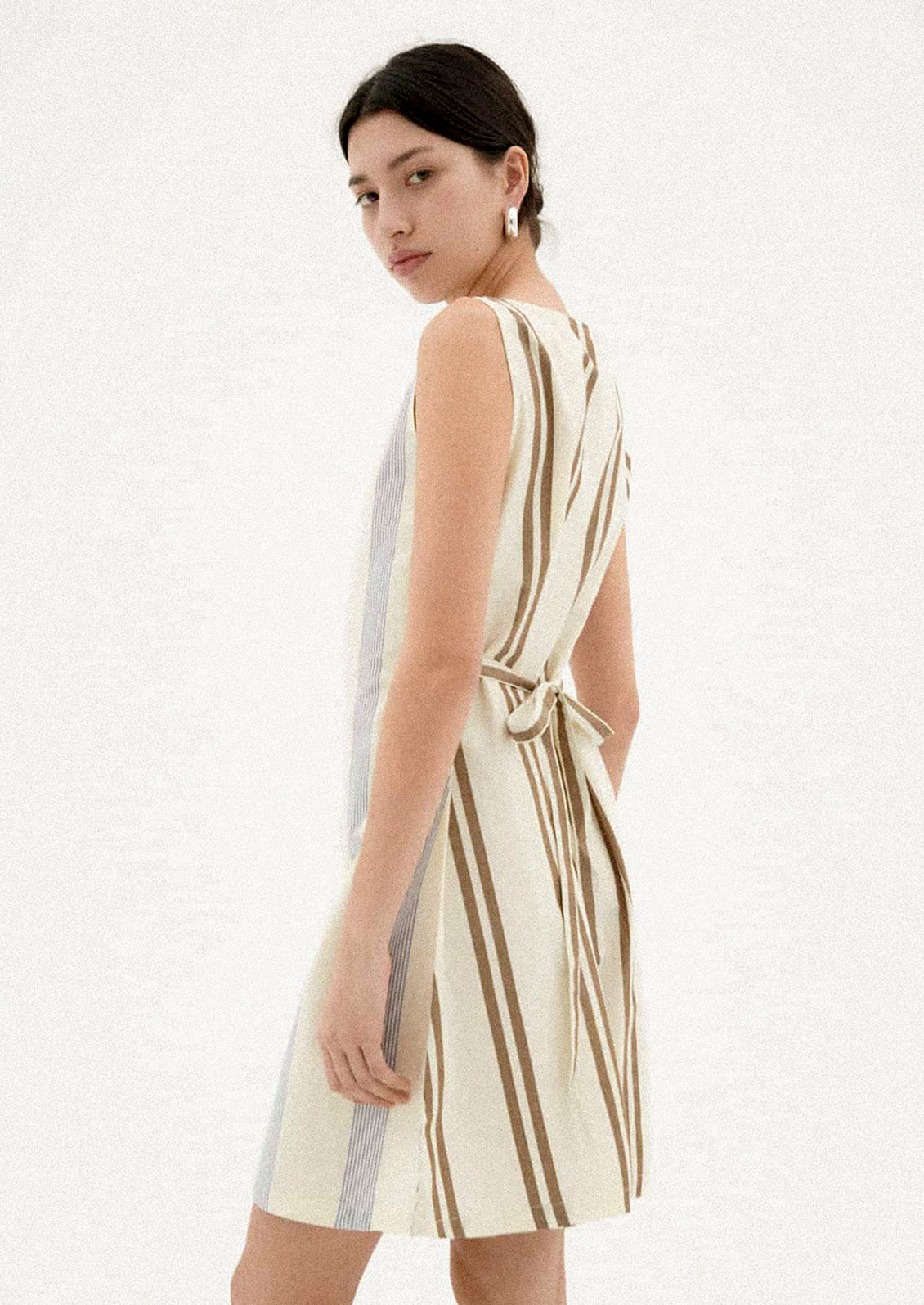 A woman wearing a two-tone striped short dress.