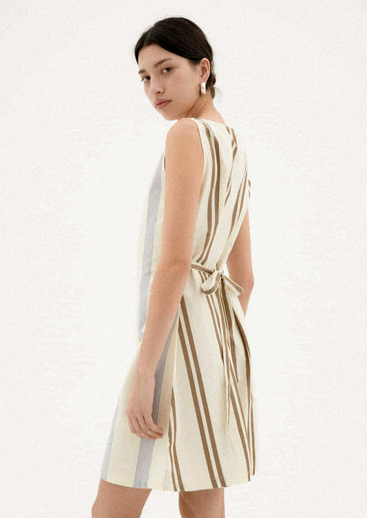 A woman wearing a two-tone striped short dress.