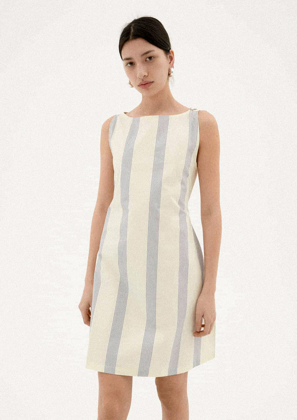 A woman wearing a two-tone striped short dress.