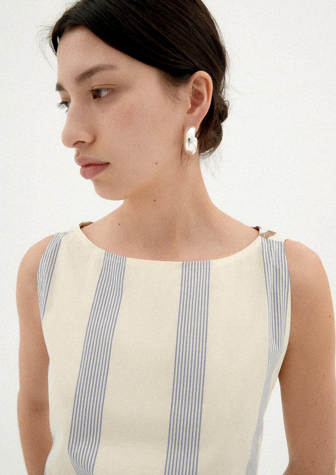 A woman wearing a two-tone striped short dress.