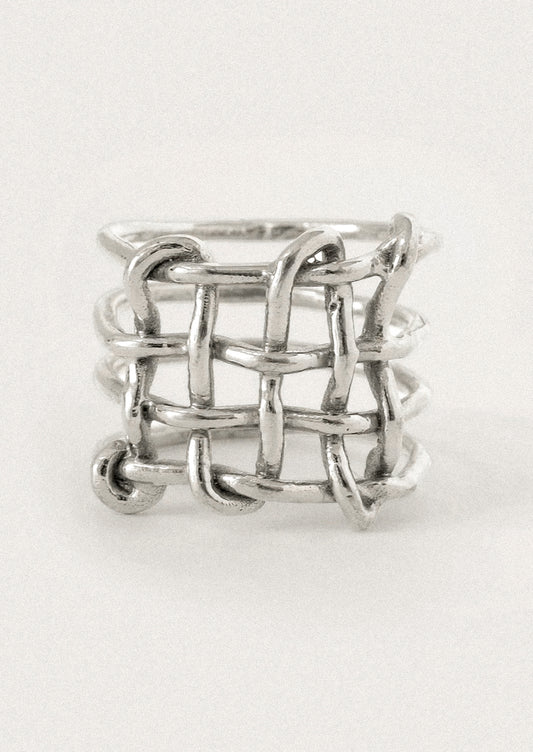 A silver ring with a textured, interlocking chain-link or woven basket-like design.