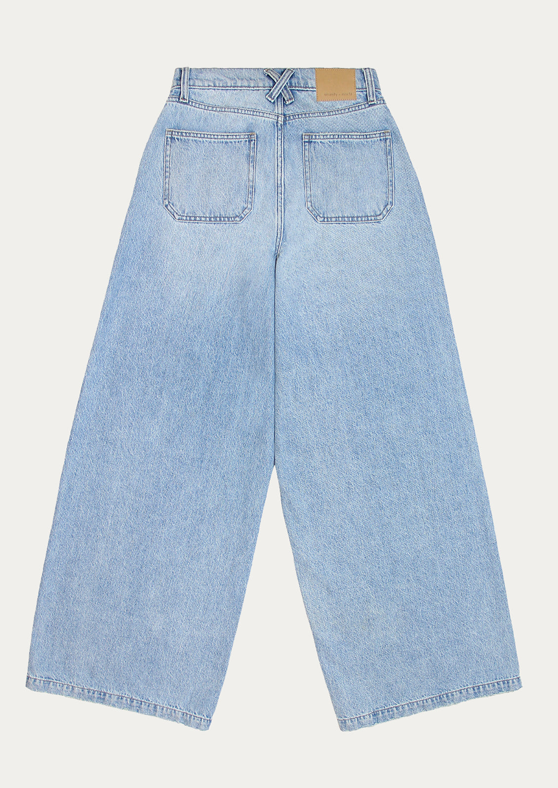 A pair of medium wash wide leg jeans.