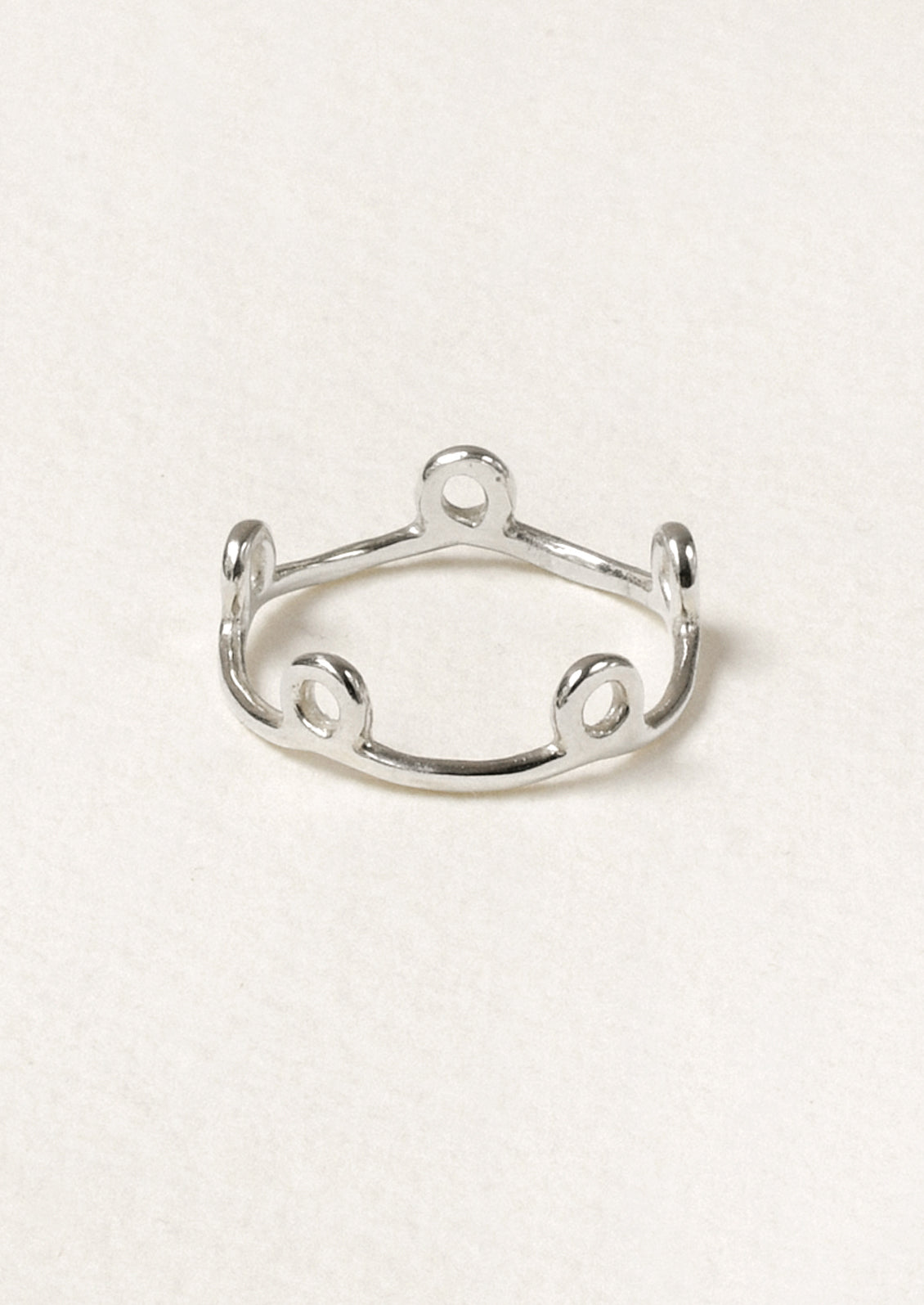 A sterling silver ring with small circles along the band.