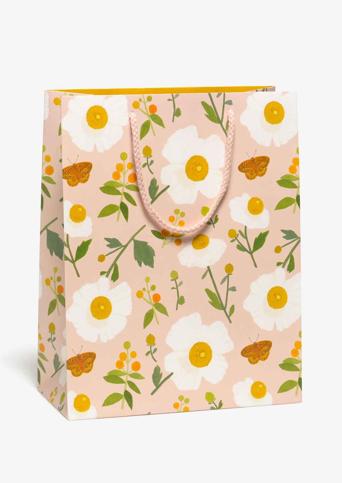 A peach colored gift bag with white poppy and moth print.