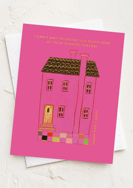 A pink card reading "I can't wait to have too much wine at your dinner parties - Happy new home!".