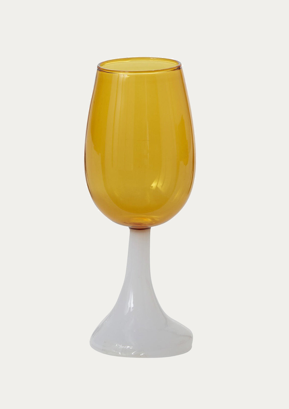Yellow glass wine glass with opaque white base.